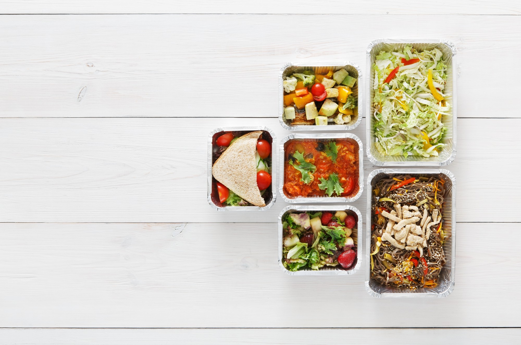 Assorted meal kit boxes staged on wooden table