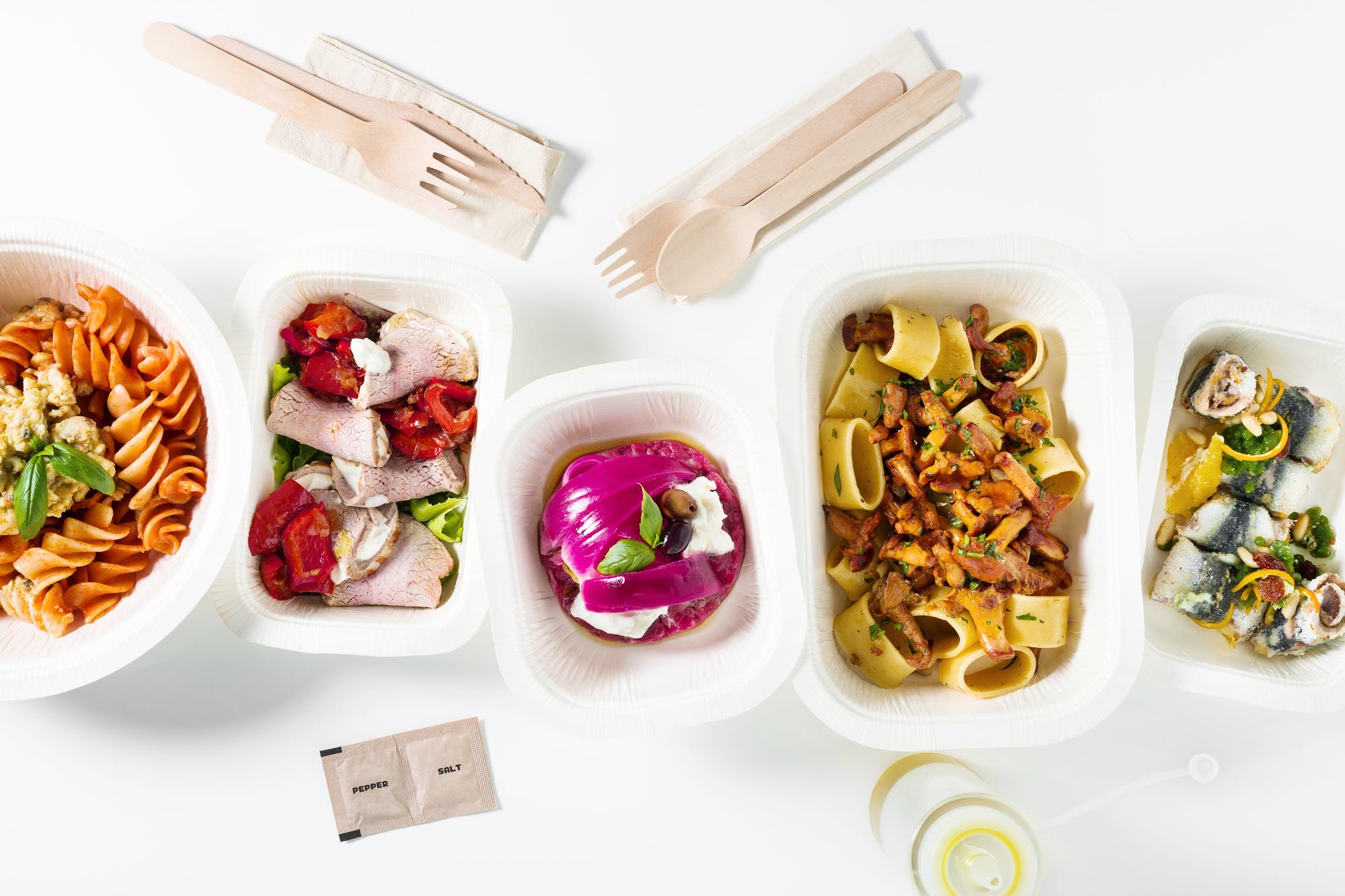 Neat kit boxes and plated meal on table